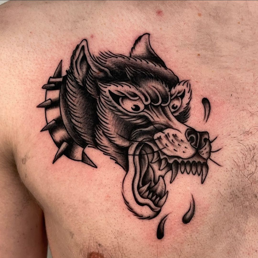 Detailed tattoo of a fierce dog on the chest.