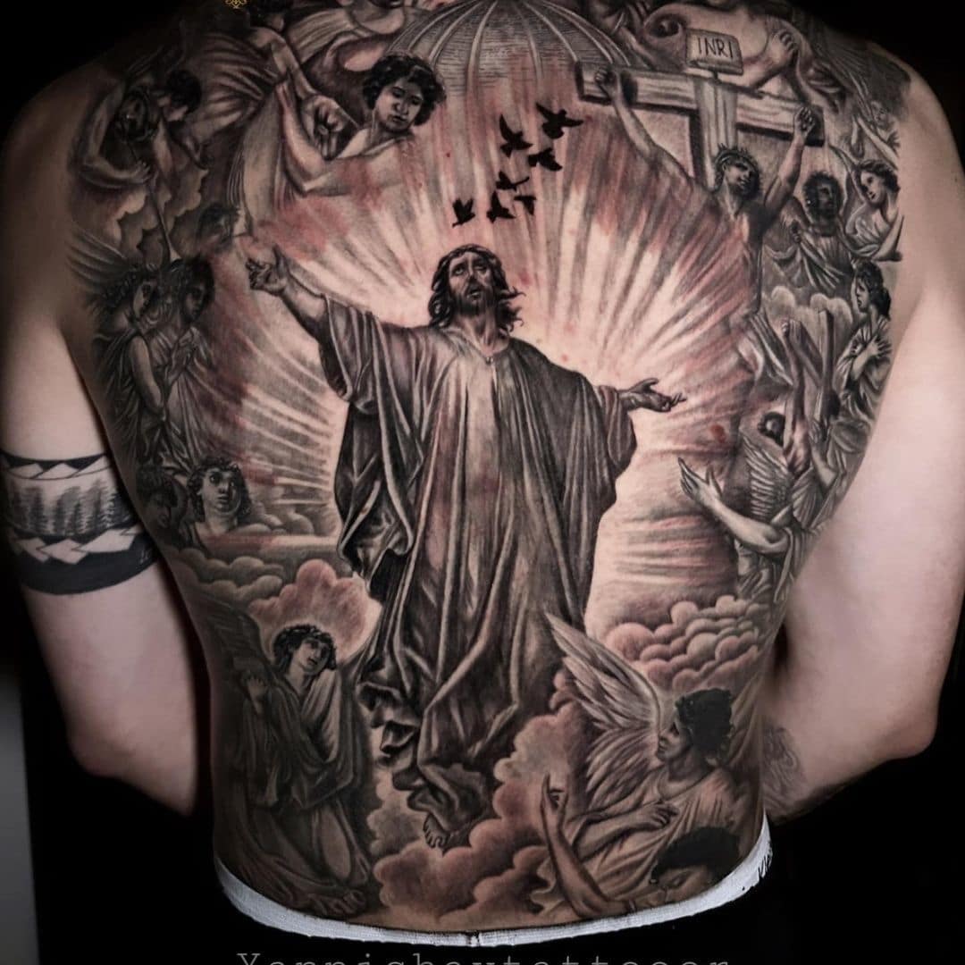 Detailed back tattoo featuring Jesus surrounded by angels and birds