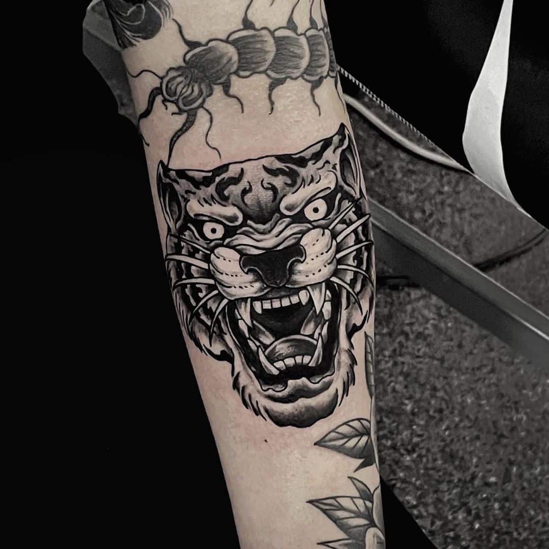Black and gray tiger tattoo on arm