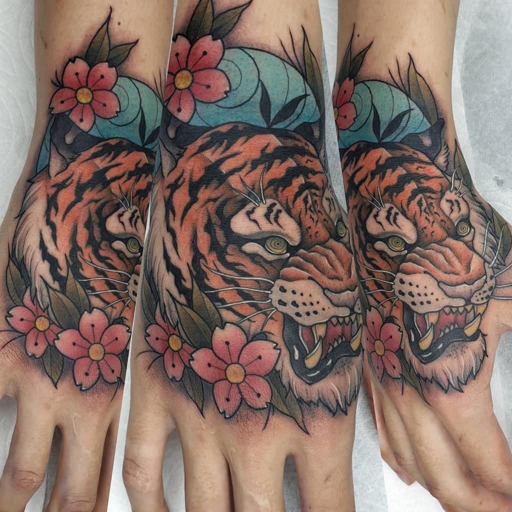 Colorful tiger tattoo on hands with flowers