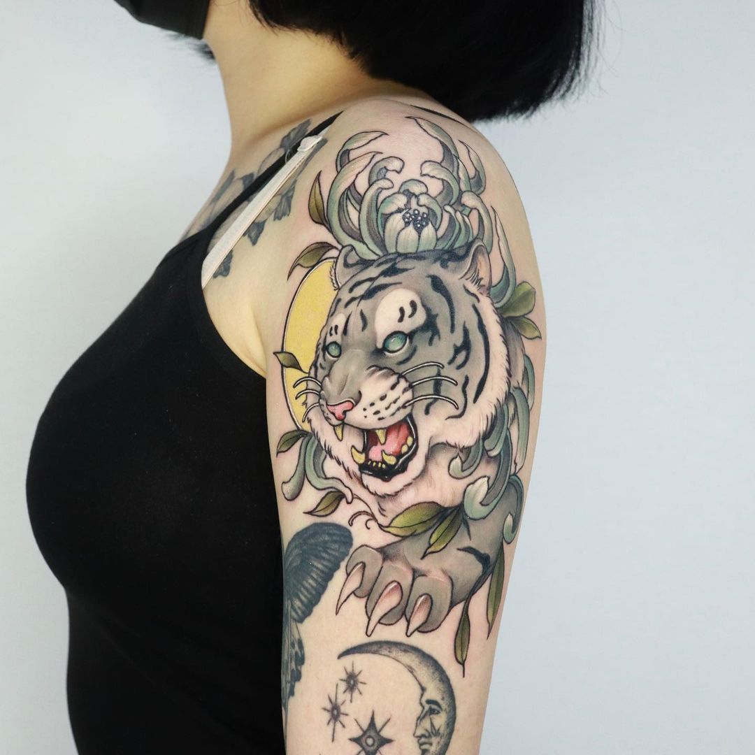 Tattoo of a white tiger on a woman's arm